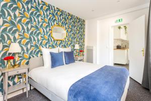 sypialnia z łóżkiem z niebieską i żółtą tapetą w obiekcie Cosy 2 bedrooms apartment with bathrooms - Louvre w Paryżu