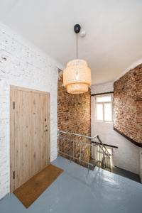 a room with a door and a brick wall at Stylish apartment in the heart of Kaunas Old Town in Kaunas