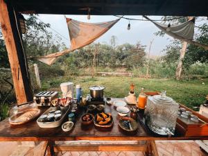 a table with food on it in a tent at THE RIVER RUNS CHIANG KLANG in Chiang Klang