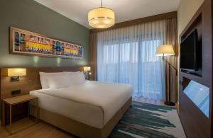 a hotel room with a large bed and a television at The Superior Living Batışehir in Istanbul