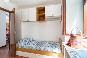 a small bedroom with a bunk bed and white cabinets at Nesso APT with Private Parking & Shared Pool! in Nesso