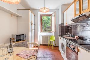 a kitchen with a sink and a stove top oven at Nesso APT with Private Parking & Shared Pool! in Nesso