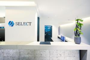 a lobby of a select office with a potted plant at Select Hotel Berlin The Wall - Apartments in Berlin