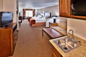 a hotel room with a bed and a television at Holiday Inn Express Hotel & Suites - Dubuque West, an IHG Hotel in Dubuque