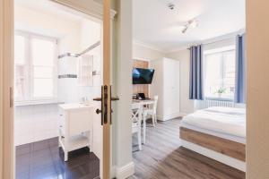 a bedroom with a bed and a desk in a room at Die Sonne Nollingen in Nollingen