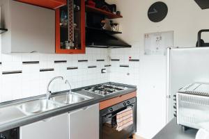 a kitchen with a sink and a stove at Il Loggione in Enna