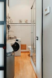 a bathroom with a sink and a washing machine at Il Loggione in Enna