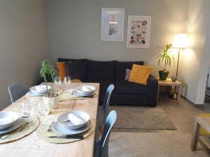 sala de estar con mesa y sofá en Le Terramon - Appartement 4 personnes, en Orbey