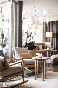 a living room with a couch and chairs and a table at Hotel Petrus in Brunico