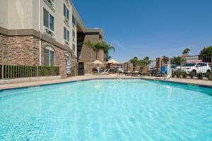 una gran piscina frente a un edificio en Holiday Inn Express Fresno South, an IHG Hotel, en Fresno