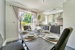 a dining room with a table with plates and wine glasses at Guest Homes - Walkers Lane House in Worcester