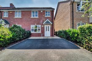 a brick house with a driveway in front of it at Guest Homes - Walkers Lane House in Worcester