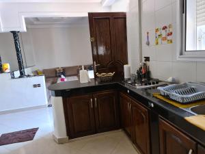 a kitchen with a refrigerator and a counter top at Amam's Home in Agadir