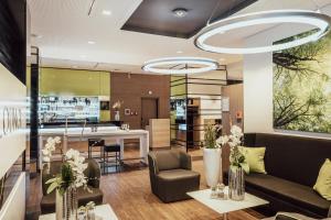a lobby with a couch and chairs and a counter at Select Hotel Style Berlin in Berlin