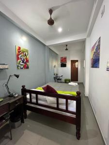 Postel nebo postele na pokoji v ubytování Chez Prabha Homestay