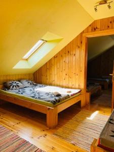 a bedroom with a bed in a room with a ceiling at Kempings Raganas slota in Vārve