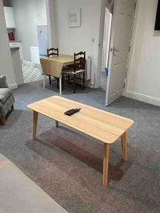 a living room with a coffee table and a dining room at Newly refurbished one bedroom apartment in Preston
