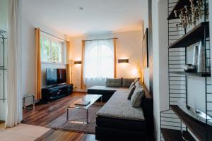 a living room with a couch and a tv at Ferienwohnung am KunstTurm in Weimar