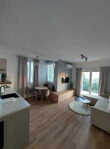 a living room with a couch and a table at Nautica apartments&studios in Peštani