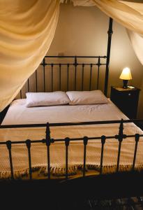 a bedroom with a bed with a canopy at Eveleos Country House in Tochni
