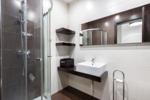 ein Bad mit einer Dusche, einem Waschbecken und einem Spiegel in der Unterkunft SLIEMA 2 Bedroom Apartment-Hosted by Sweetstay in Sliema