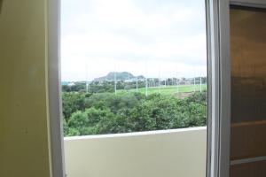 an open window with a view of a field at SWEET HOMES in Hyderabad