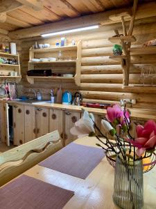 a kitchen with a table with a vase of flowers at Mont Blanc Family Sporthotel in Vyshka