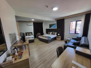 a living room with a bed and a couch at MALATYA NORVIA HOTEL in Malatya