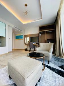 a living room with a couch and a table at Panorama Apartment Sunset Nha Trang City in Nha Trang
