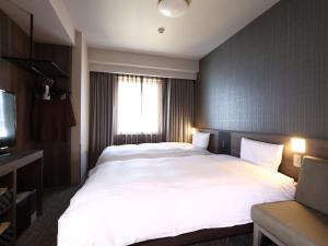 Voodi või voodid majutusasutuse Dormy Inn Okayama Natural Hot Spring toas