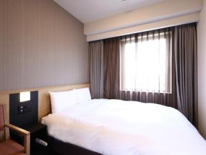 Voodi või voodid majutusasutuse Dormy Inn Okayama Natural Hot Spring toas