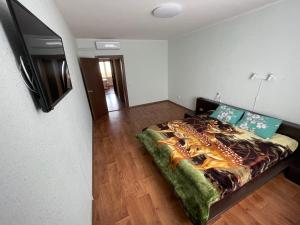 a bedroom with a bed and a flat screen tv at Квартира в новому будинку in Kyiv