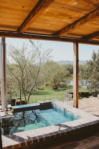 a swimming pool in a house with a wooden roof at De Uijlenes in Gansbaai