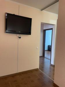 a living room with a flat screen tv on the wall at Квартира в новому будинку in Kyiv
