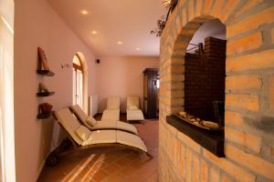 a living room with a couch and a brick wall at Napvirág-Ház in Zsira