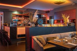 ein Restaurant mit zwei Tischen und einer Bar in der Unterkunft Qube Hotel Bergheim in Heidelberg