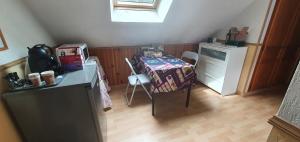 a small room with a table and a dresser at La maison du Roi Vives Eaux in Boissise-le-Roi