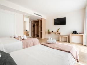 Posteľ alebo postele v izbe v ubytovaní limehome Barcelona Carrer de Besalú 82