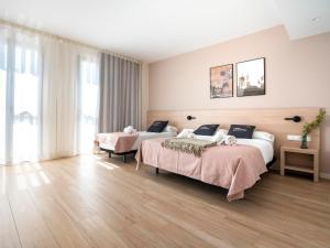 Posteľ alebo postele v izbe v ubytovaní limehome Barcelona Carrer de Besalú 82