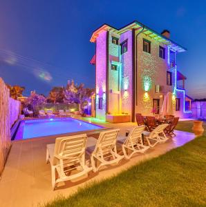 a villa with a swimming pool at night at Villa Grando 2 in Kas