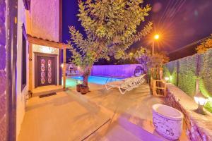 a backyard with a swimming pool at night at Villa Grando 2 in Kaş