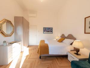 a bedroom with a bed and a mirror and a couch at The Best Rent - Bright apartment near Isola Tiberina in Rome