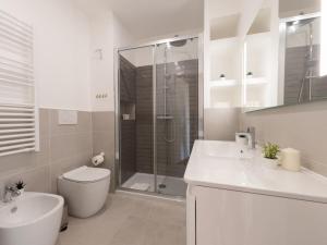a bathroom with a shower and a toilet and a sink at The Best Rent - Bright apartment near Isola Tiberina in Rome +10 photos