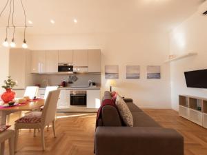 a living room and kitchen with a couch and a table at The Best Rent - Bright apartment near Isola Tiberina in Rome