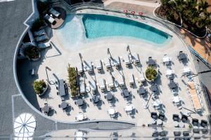 an overhead view of a pool with lounge chairs and a swimming pool at Oceans Umhlanga Accommodation in Durban