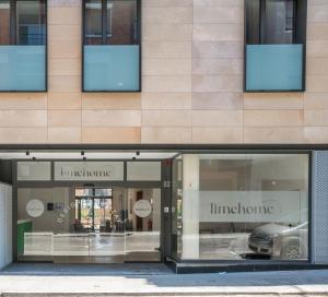 a store front with two store windows with a car in it at limehome Barcelona Carrer de Besal&uacute; 82 in Barcelona