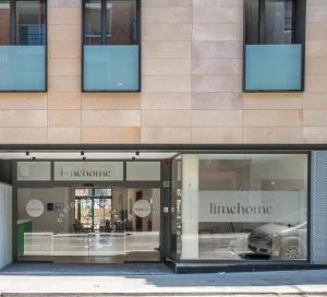 a store front with two store windows with a car in it at limehome Barcelona Carrer de Besalú 82 in Barcelona