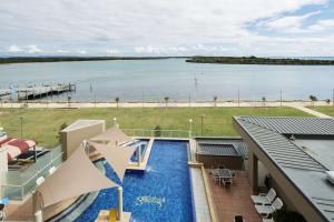 a view of a swimming pool with a view of a body of water at Rydges Hotel Port Macquarie in Port Macquarie