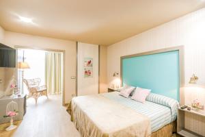 a bedroom with a bed and a large window at POSADA El ABUELO DE LA CACHAVA in Gajano +110 photos