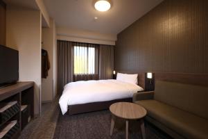 Voodi või voodid majutusasutuse Dormy Inn Okayama Natural Hot Spring toas